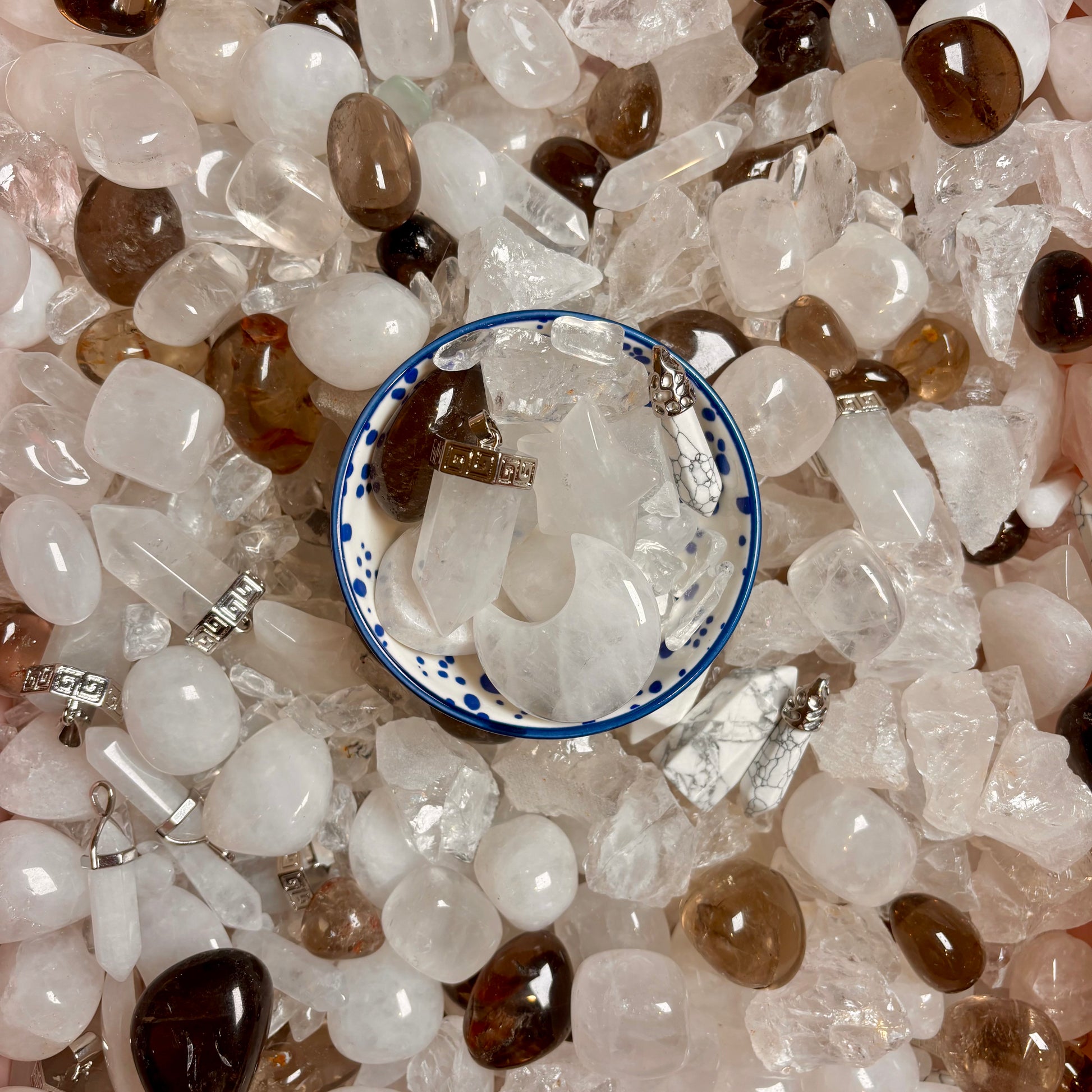 Close-up of a pile of clear quartz and white crystals and gemstones.