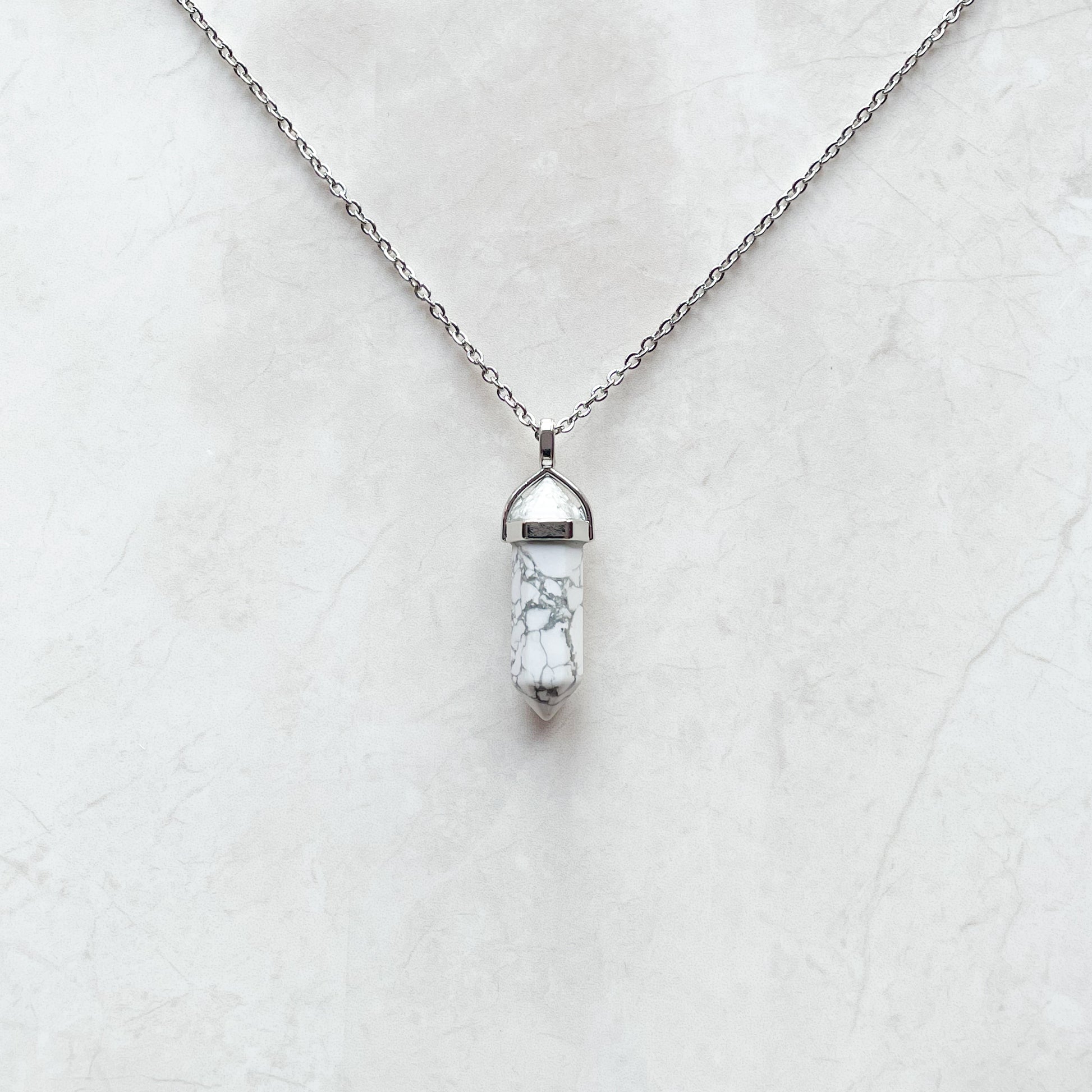 grey and white marble crystal on a necklace
