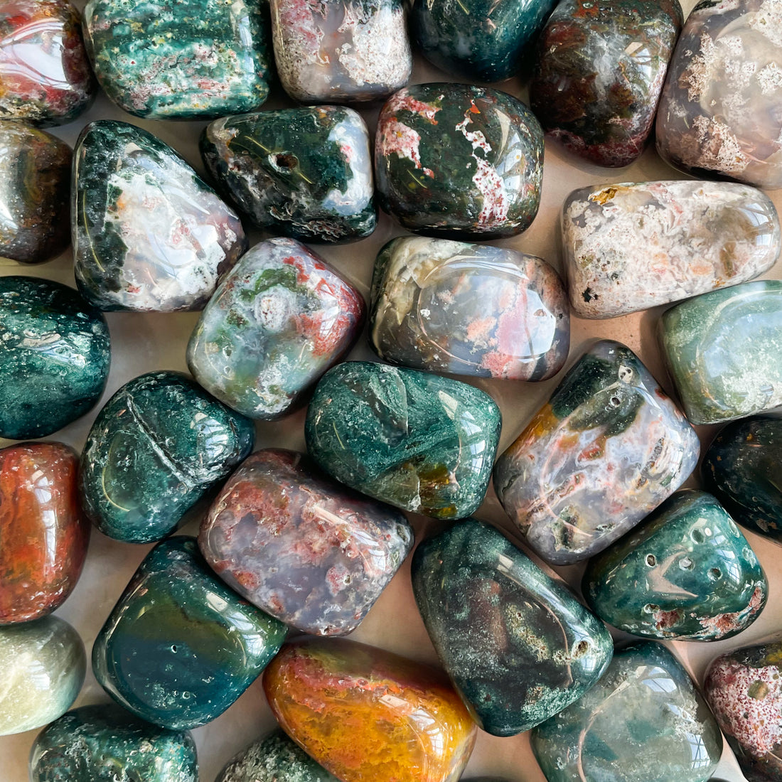 a handful of beautiful green small tumbles made from Ocean Jasper