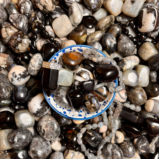 Close-up of a bowl with jewellery and crystal tumbles