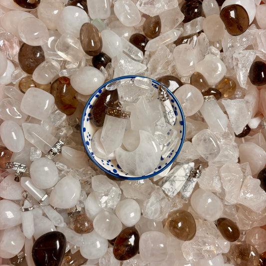 Close-up of a pile of clear quartz and white crystals and gemstones.